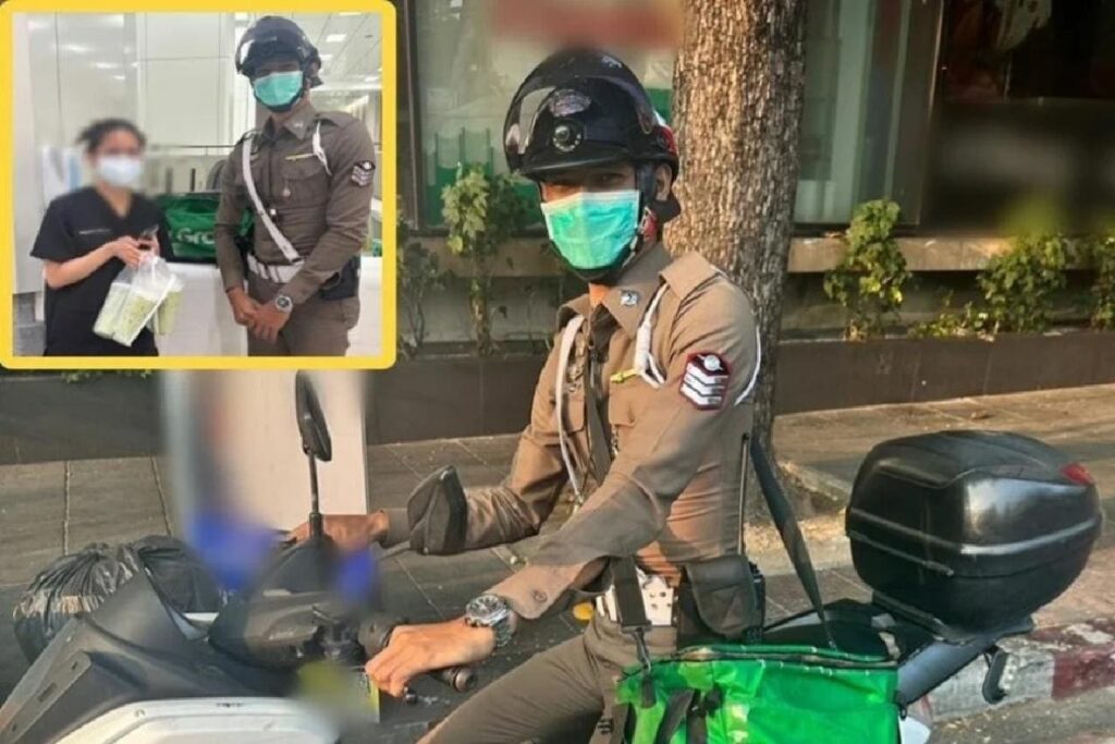 Un policier thaïlandais livre la nourriture d'un chauffeur Grab accidenté