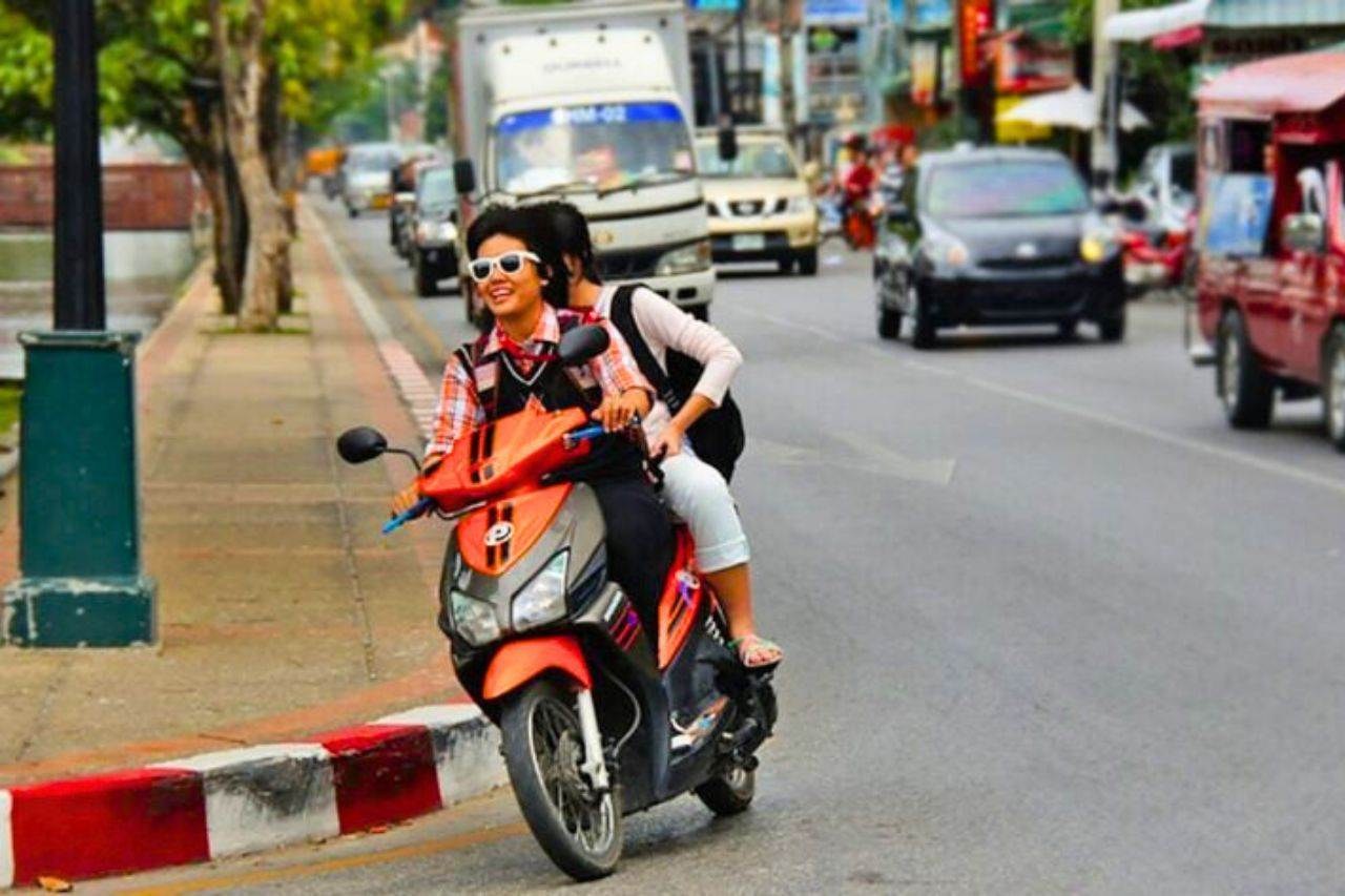 Tourism operators in Thailand denounce police corruption 7 Thai man on a motorcycle without a helmet