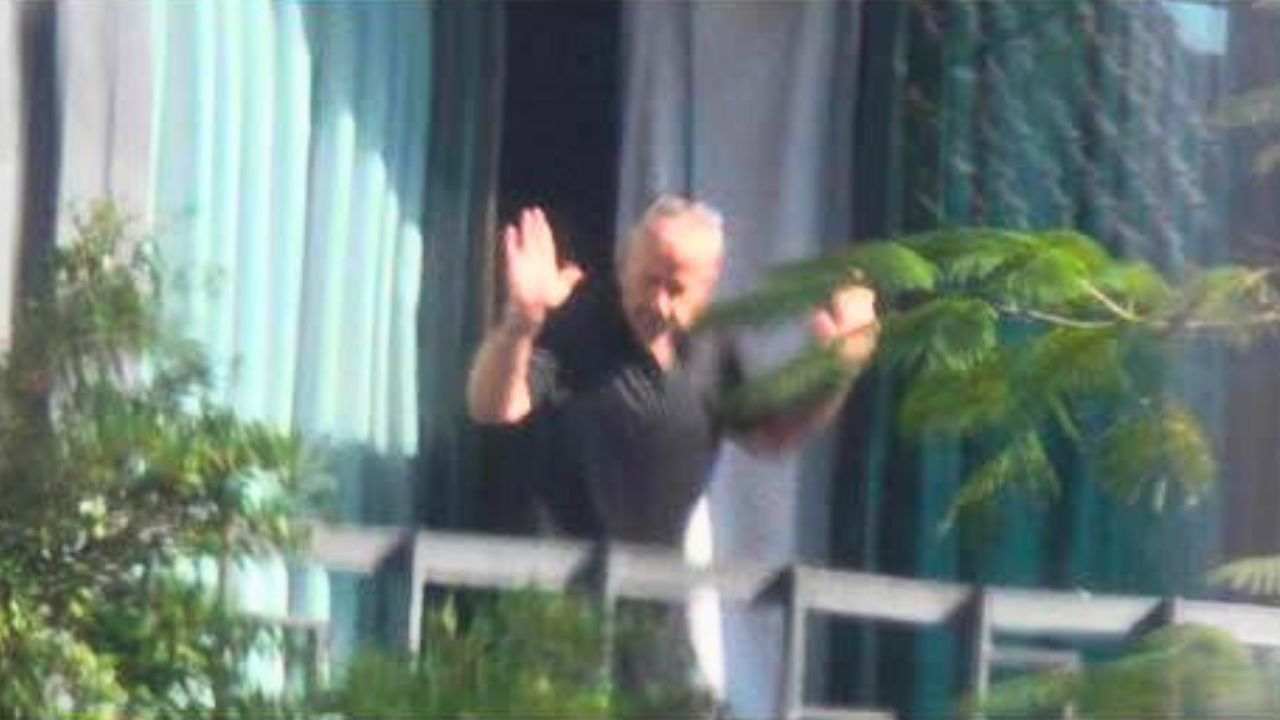 The Briton hands up surrenders to the police.