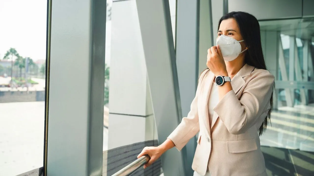 Femme avec un masque dans une zone polluée de Thaïlande