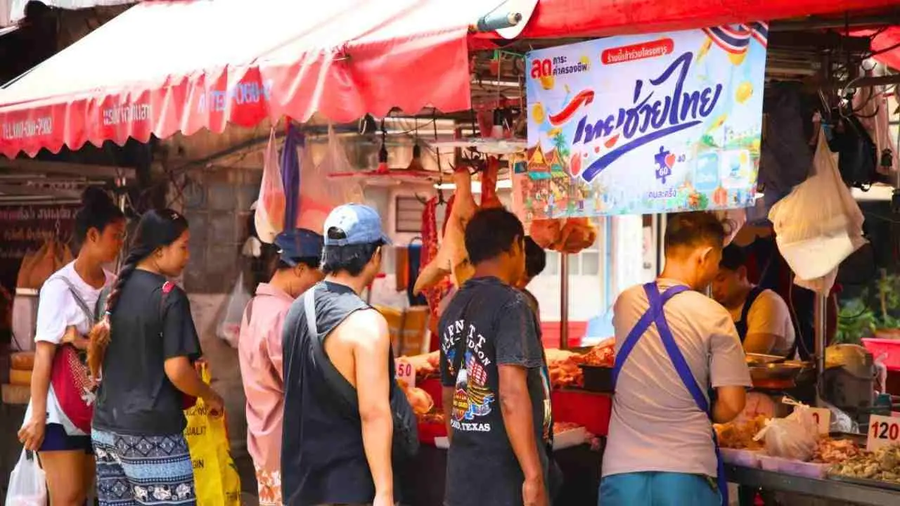 Des clients font leurs achats au marché de Bang Kapi de Bangkok lors de la première journée de la campagne « Thais Help Thais Plus »
